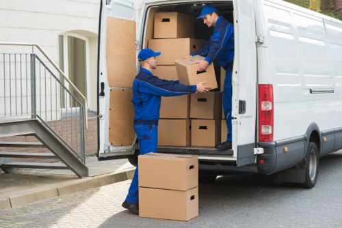 Movers handling boxes and household items in a Bromley property