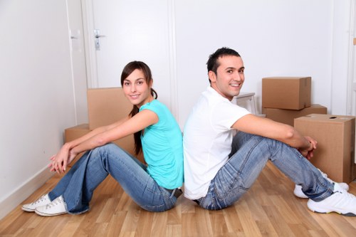 Workers carefully loading furniture and boxes into a moving van